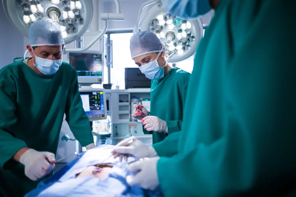 surgeons performing operation in operation theater of hospital