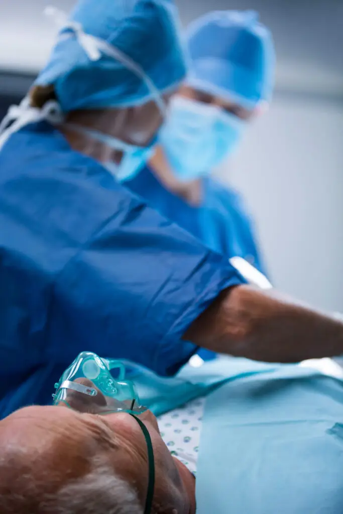 surgeons performing operation in operation room